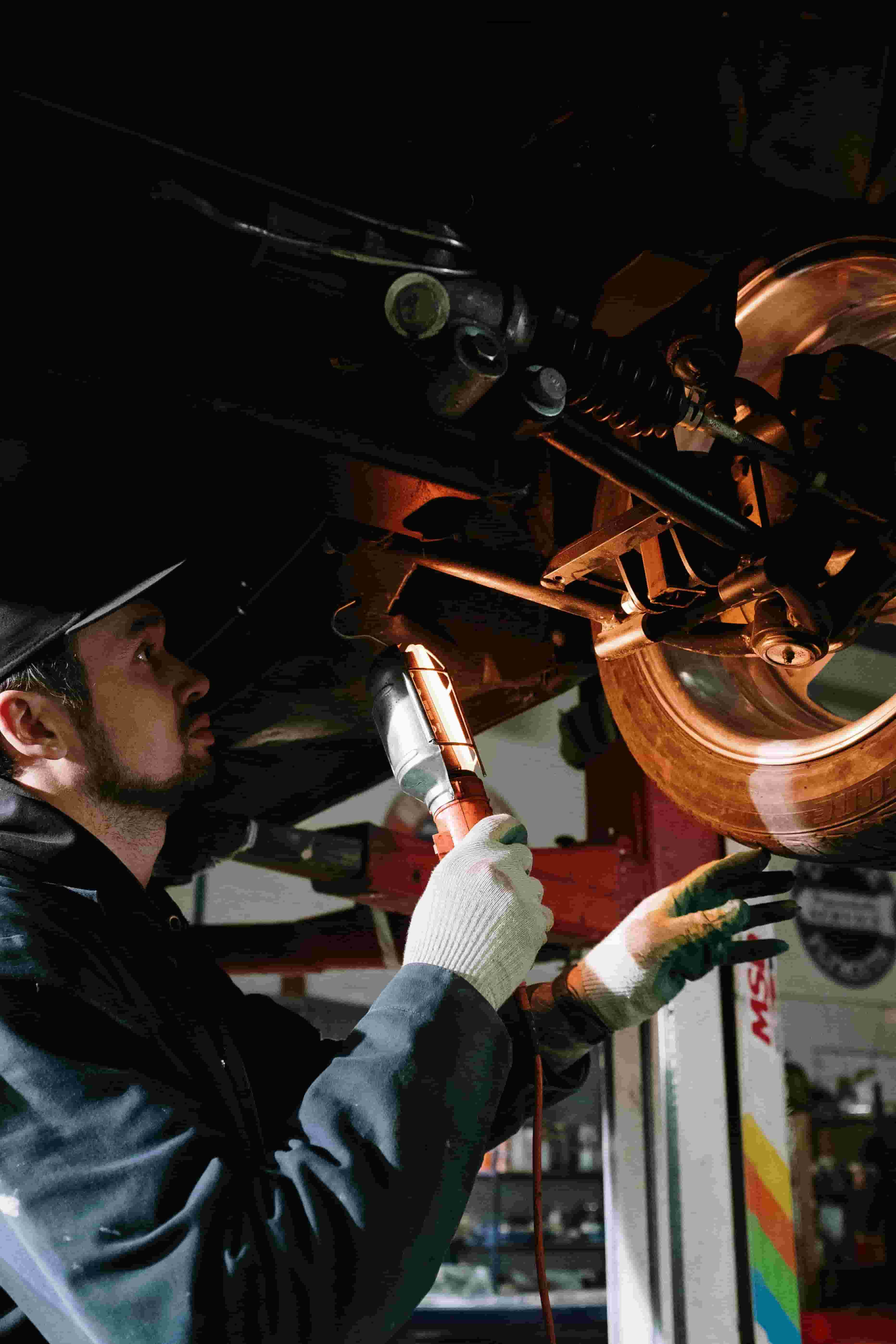 Technicians working on a vehicle in the garage
